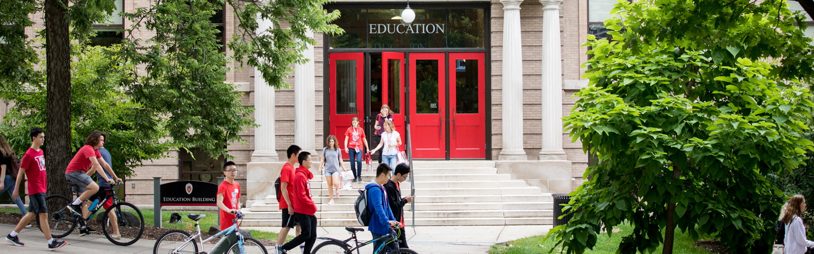 The Education Building's red doors with students walking in and out