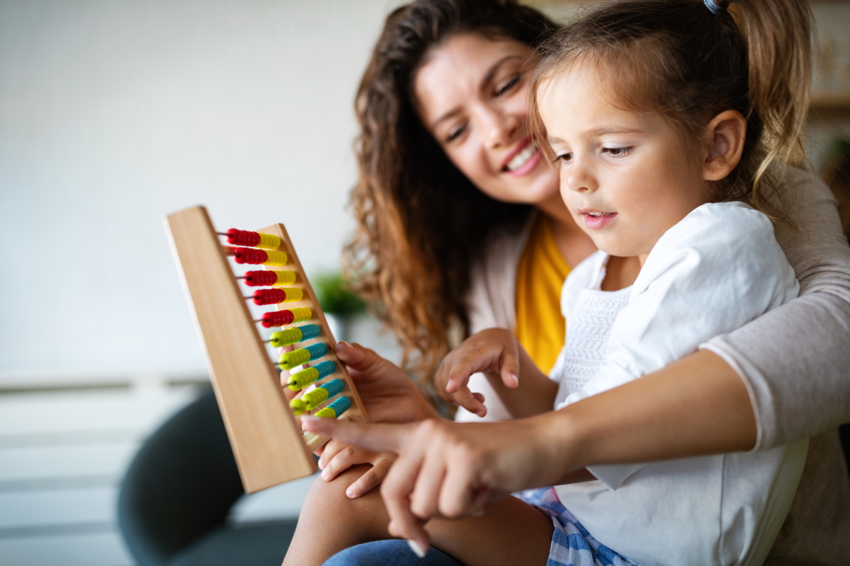 Mother and little girl, kid playing with abacus, early education