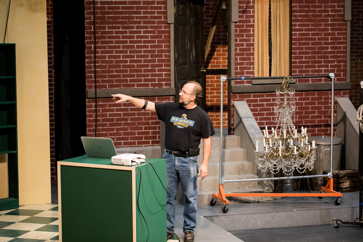 Set design instructor Shuxing Fan takes his students to The Mitchell Theater to listen to a presentation by Scene Studio Supervisor Rob Wagner. Rob is discussing the set design and building process for the play Little Shop of Horrors.